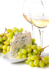 Two glasses of white wine, blue cheese and a grapes