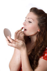 Naklejka premium beautiful sexy woman putting on red lipstick