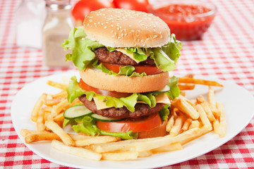 Double hamburger with cheese, lettuce and tomato