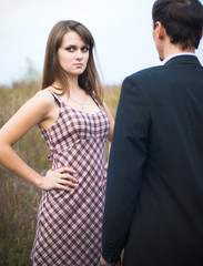 Woman looking offended over man shoulder
