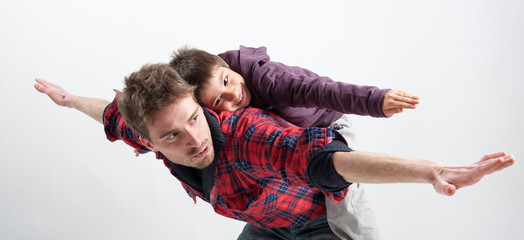Young father and son playing together portrait. Studio shot. © pio3