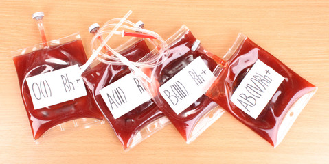 Bags of blood and infusion on wooden background