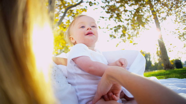 Cute Baby and Mom playing Outdoors