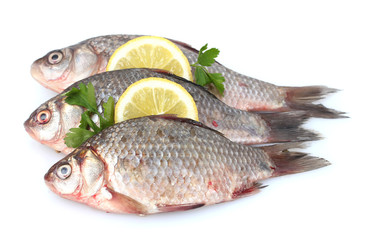 Fresh fishes with lemon and parsley isolated on white
