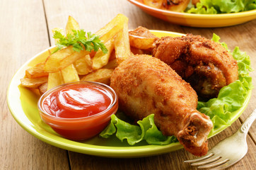 Fried drumsticks with french fries