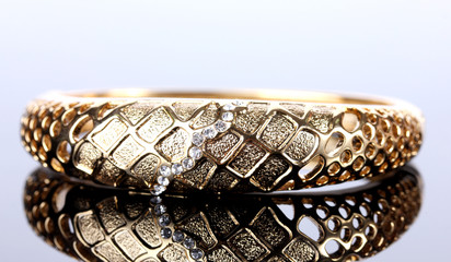 Fototapeta premium Beautiful golden bracelet with precious stones