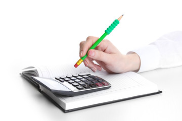 women hand with pencil, notebook and Calculator isolated