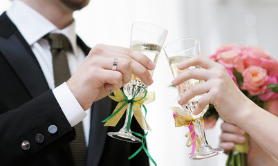 Bride and groom holding champagne glasses