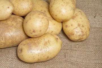 Potatoes on hessian sack background