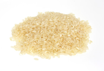 PILE OF BROWN RICE ISOLATED ON WHITE BACKGROUND