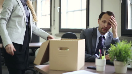 Shocked young businessman is getting fired by his boss
