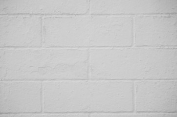 Brick wall painted with a white paint