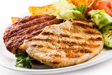 Grilled steaks, baked potatoes and vegetable salad