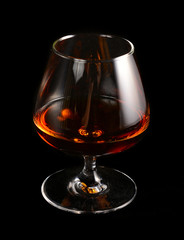 Glass of brandy over black