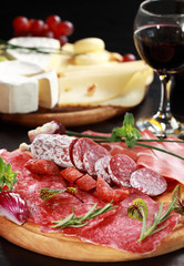 Salami and cheese platter with herbs