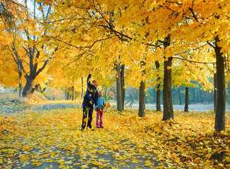 Family in autumn maple park