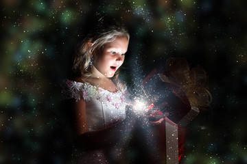 Child opening a magic gift box