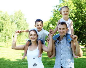 Family with two children in the summer park