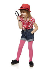 Full length of little girl with magnifying glass