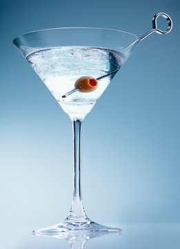 Shaken martini cocktail with olive