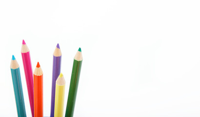 Close up of color pencils with different color over white backgr