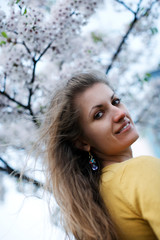 Young woman with flowers of sakura