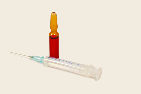 Syringe with an ampoule on a white background