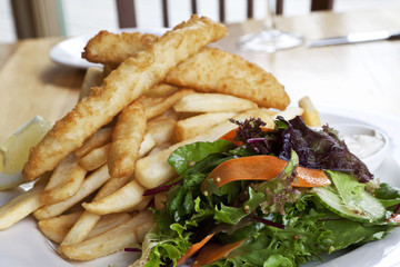 Fried fish and potatoes with salad