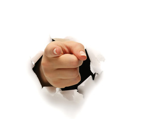 A female hand breaking through paper pointing at you