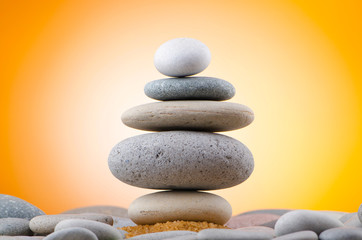 Balanced pebbles with colour background