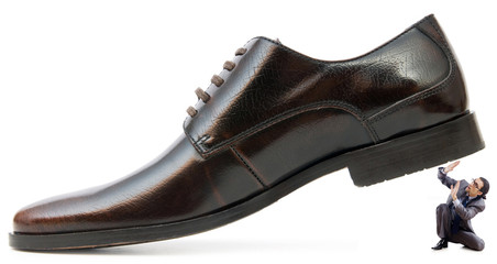 Woman domination concept with shoes and man