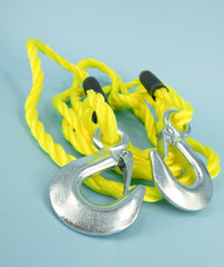 Yellow towing rope with metal hooks for car transportation