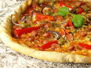 Close-up of pizza with vegetables and sausages