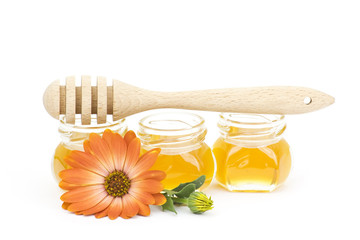 honey and flowers on white