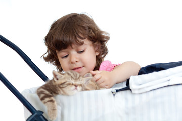 funny child playing with attractive kitten