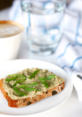 Fish pâté or spread with scallions on whole grain slice of bread