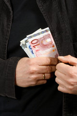 Man with euros in their pockets, close-up