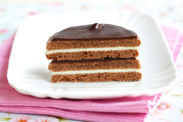 Sandwich biscuit with layered chocolate ganache, halved