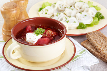 Russian cuisine. Borscht and pelmeni on the served table