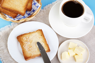 Breakfast. A cup of coffee and toasts with butter