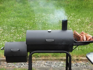 Foto auf Leinwand Backyard barbequing on a charcoal smoker © pr2is