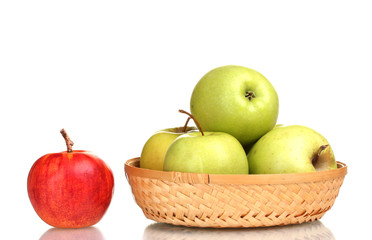 juicy green apples in the basket and red apple isolated on white