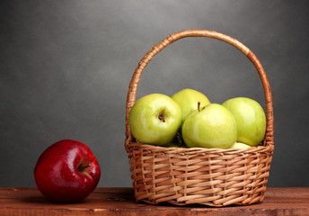 juicy green apples in basket and red apple