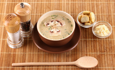 Tasty soup on wooden mat