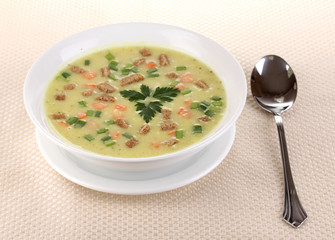 Tasty soup on beige tablecloth isolated on white