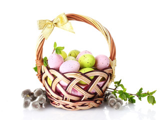 basket with Easter eggs and pussy-willow twigs isolated on white