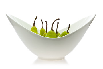 Pears in bowl on white background