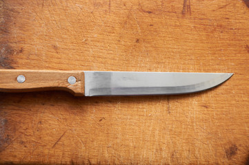 Knife on an old chopping board