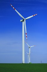 Fototapeta na wymiar Wind turbines over blue sky