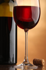 Still-life with a wine bottle, a glass and a cork